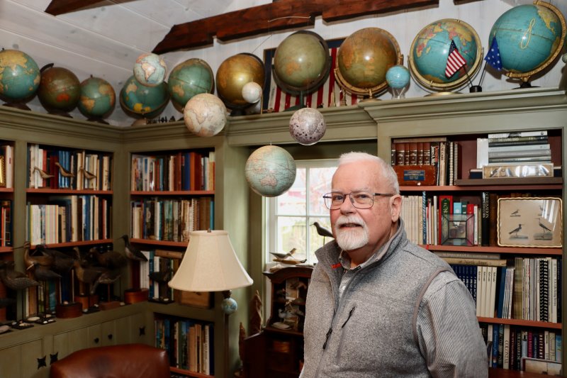 Kevin Moore’s library includes his globe collection. BILL SHULL PHOTO